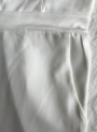 white-sleeveless-open-frent-wide-leg-jumpsuit